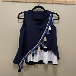 Navy & white sleeveless top with tassels and pleats.